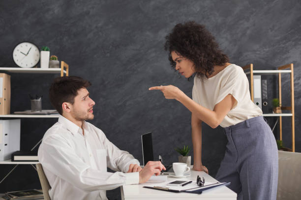 istock Couple of young colleagues arguing at office 958847678