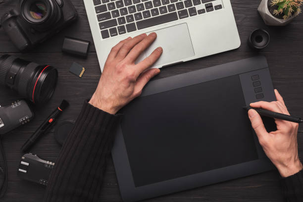 istock Designer hand with graphic tablet and keyboard 958871650