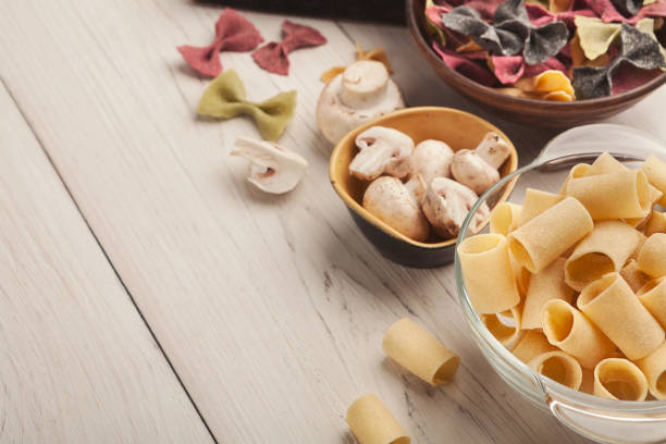 istock Various types of handmade pasta on white background 958872310