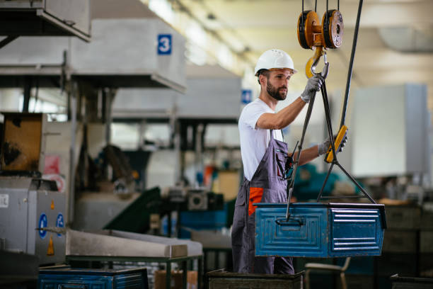 istock Young male engineer in factory using lifting beam 958878346