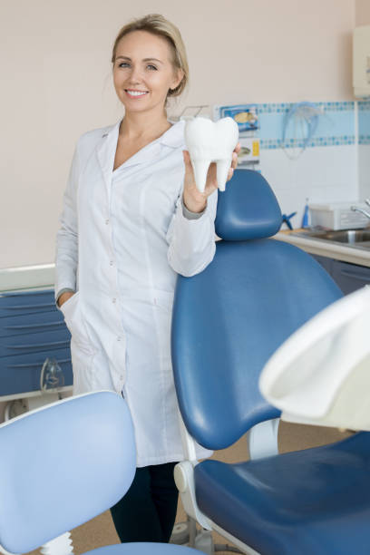 istock Pretty Female Dentist Posing in Modern Office 958878866