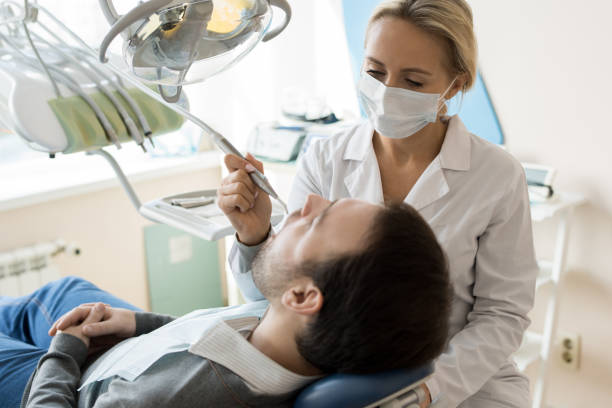 istock Young Female Dentist Treating Patient 958878868