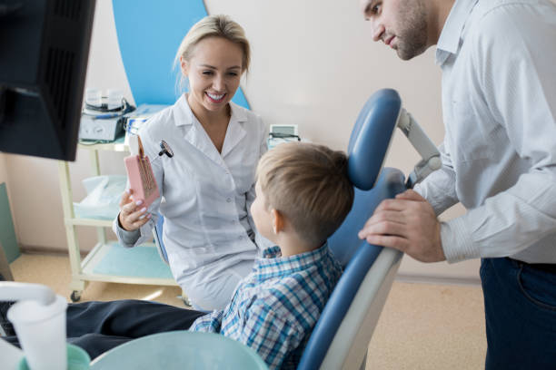 istock Friendly Dentist Working with Little Kid in Clinic 958878930