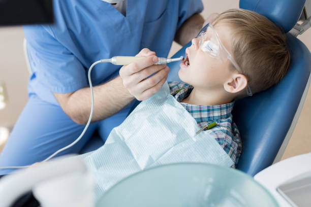 istock Dentist Treating Little Boy 958878980