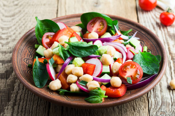 istock Chickpea and fresh vegetables salad in ceramic bowl 958879366