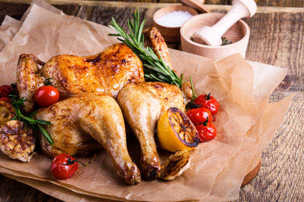 Roasted chicken with lemon, tomatoes and rosemary herbs