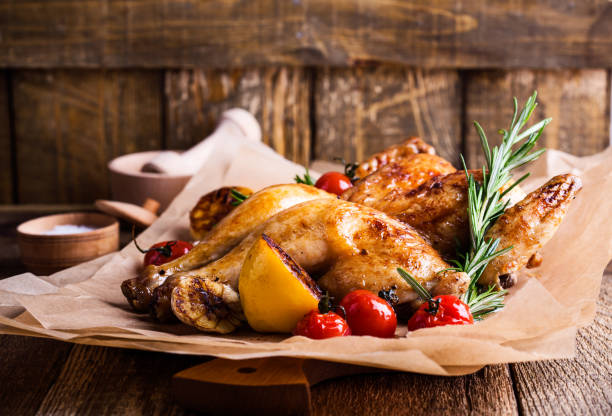 Roasted chicken with lemon, tomatoes and rosemary herbs