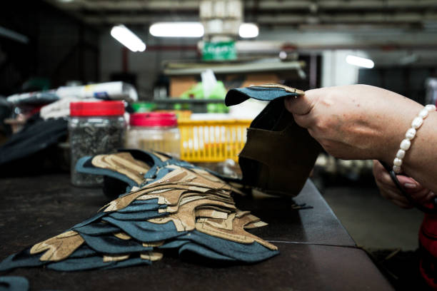 istock Cutting leather for shoe making with material and equipment 958886182