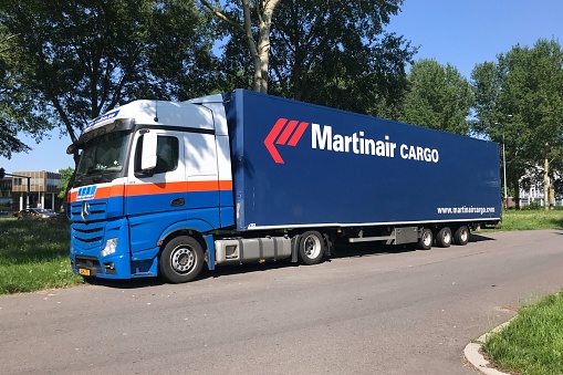 Heavy blue truck on a two lane road crossing the Danish island Funen