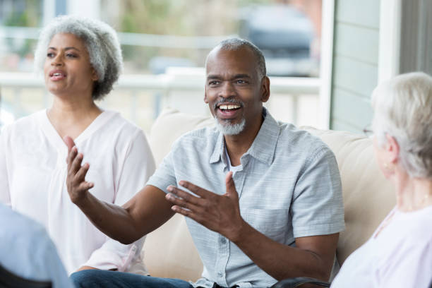 istock Senior man gestures while discussing something with his friends 958888132