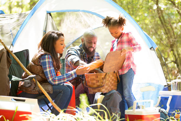 istock Family on summer or autumn vacation camping in forest. 958888280
