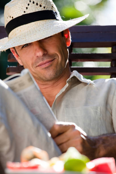 istock man reading a magazine in summer 958891094