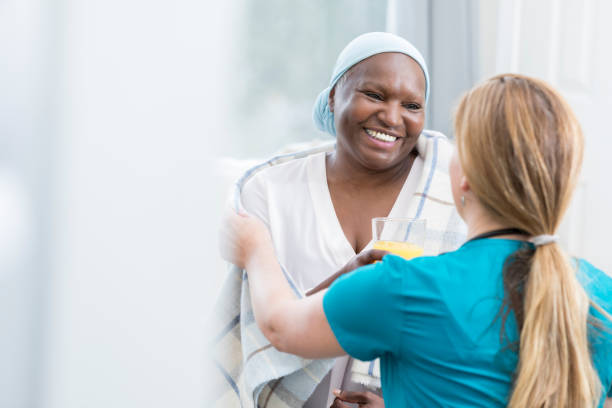 Caring nurse assists senior patient Home healthcare nurse assists a smiling senior patient. The nurse is wrapping a blanket around the senior woman. doctor utensils stock pictures, royalty-free photos & images