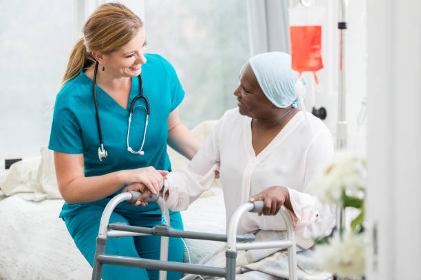 istock Nurse helps woman uses mobility walker 958891816