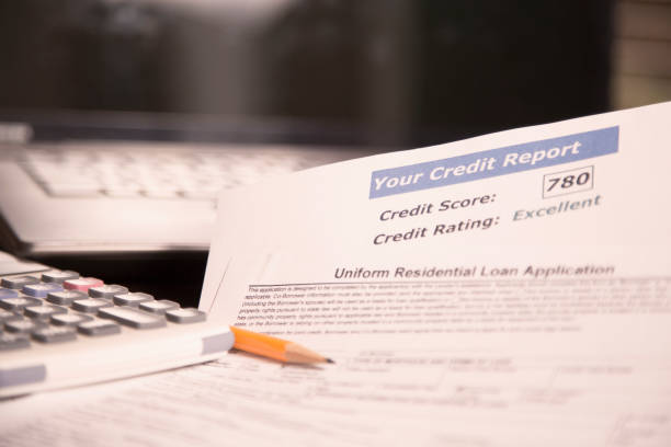 istock Credit report, score, loan documents, laptop, and calculator on desk. 958891870