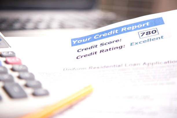 istock Credit report, score, loan documents, laptop, and calculator on desk. 958892088