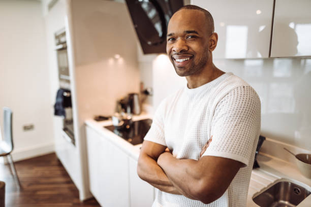 istock man portrait at home standing in the kitchen 958892728