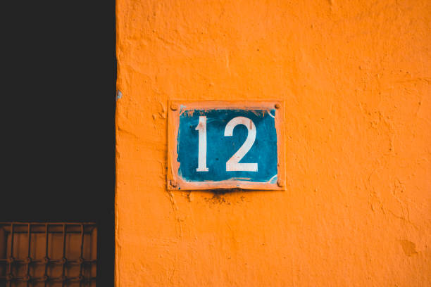 istock blue number 12 door sign on orange facade 958895854