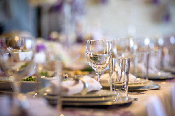 istock Beautiful table setting with crockery and flowers for a party, wedding reception or other festive event. 958902102