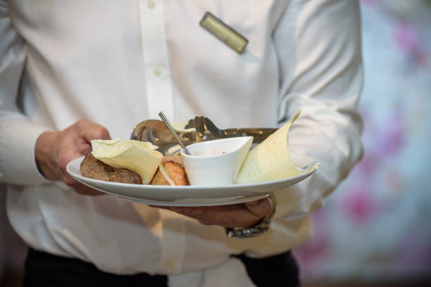 istock Waiters carrying plates with meat dish at a wedding 958902370