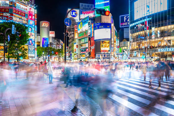 Shibuya scramble crossing at night Shibuya, Tokyo, Japan-April 15, 2018: Crowds crossing Shibuya scramble crossing, the famous intersection in Tokyo out side Shibuya station, at night. shibuya district stock pictures, royalty-free photos & images