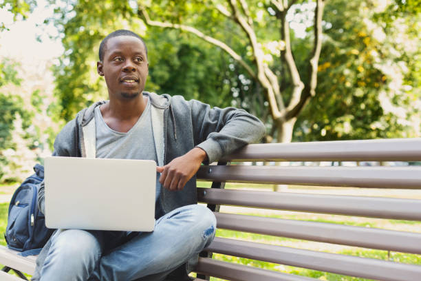 istock Concentrated man working on his laptop outdoors 958908958