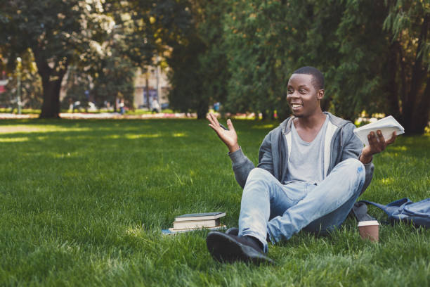 istock Young man writing in copy-book outdoors 958909870