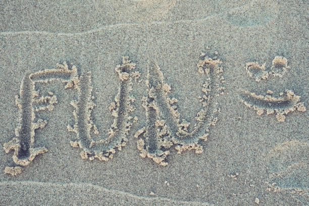istock Word „fun“ written in the sand 958910450