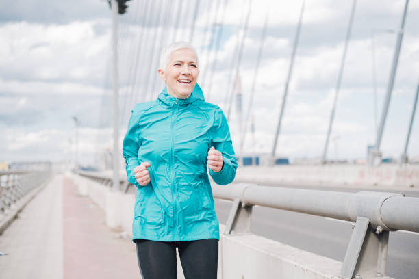 istock Mature woman jogging 958918594