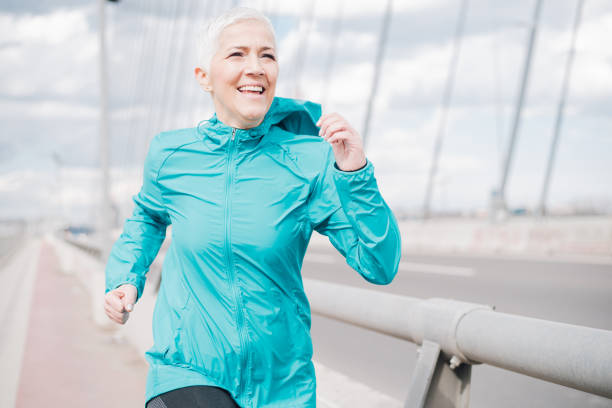istock Mature woman jogging and smiling 958918608