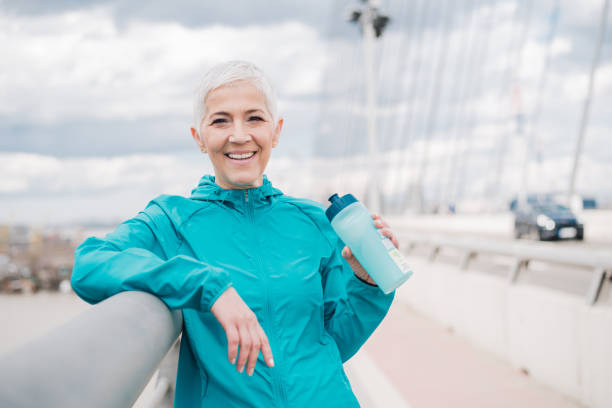 istock Happy jogger holding water bottle 958918746