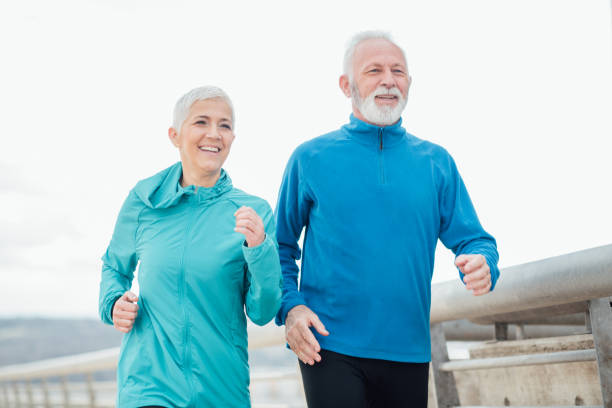 istock Happy senior couple jogging 958919976
