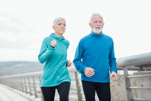 istock Elderly couple jogging outdoors 958920030