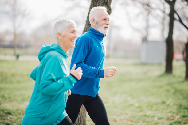 istock Happy people jogging in the park 958920346