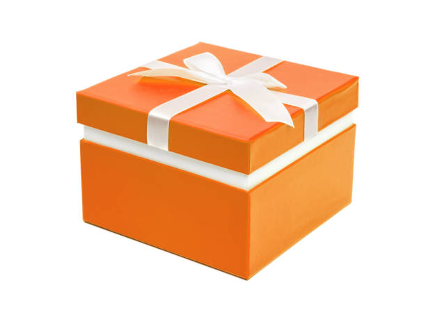istock Orange gift box with ribbon bow. Holiday present. Isolated on white background 958923332