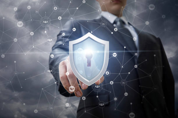 istock Businessman clicks on the shield protecting the network . 958924378