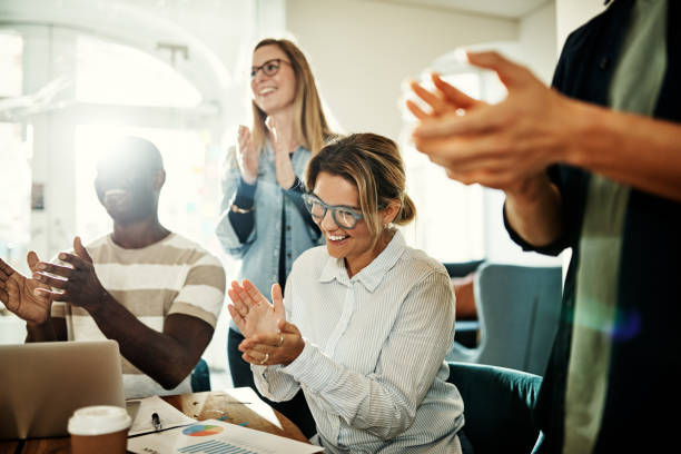 istock Laughing group of diverse colleagues clapping during an office meeting 958927320