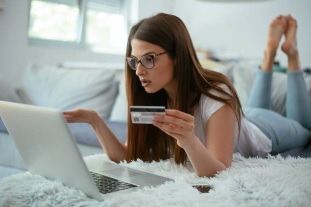 istock Young serious woman paying bills online 958928052