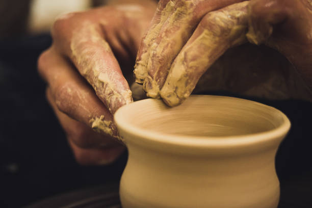 istock Creating vase of white clay close-up. Master crock 958928106