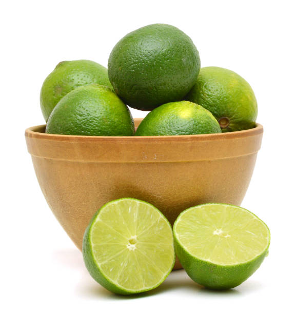 istock A green lemons on wooden bowl 958928546