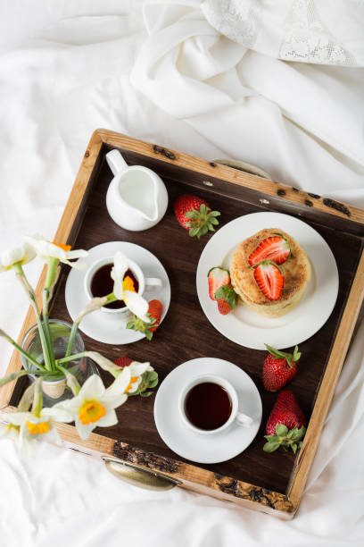 istock Breakfast in bed: cottage cheese pancakes, coffee and strawberries 958928840
