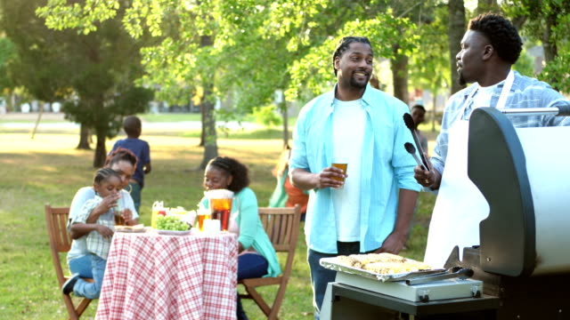Extended African-American family having cookout