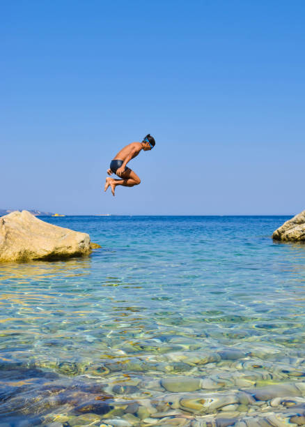 istock Jump into the sea. 958935606