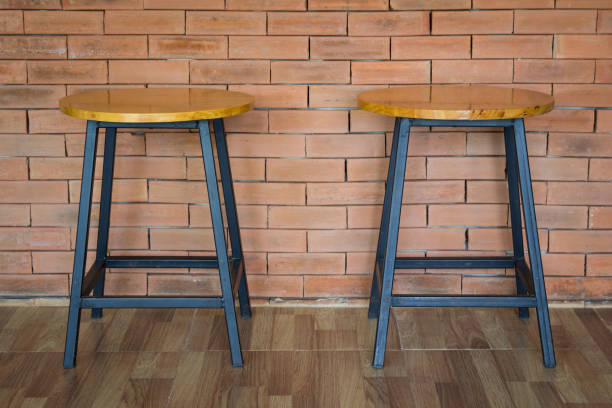 istock two wooden chairs on brick wall background 958936360