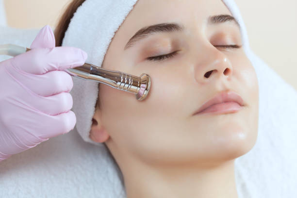 The cosmetologist makes the procedure Microdermabrasion of the facial skin of a beautiful, young woman The cosmetologist makes the procedure Microdermabrasion of the facial skin of a beautiful, young woman in a beauty salon.Cosmetology and professional skin care. microdermabrasion stock pictures, royalty-free photos & images