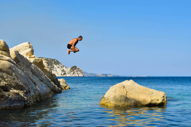 istock Jump into the sea. 958937146