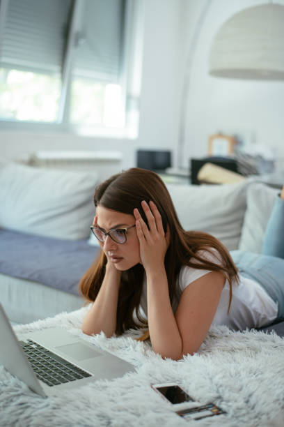 istock Worried young woman paying bills online 958937400