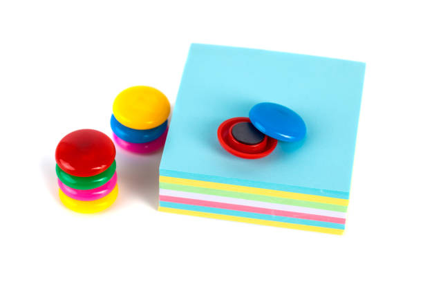 istock Colorful magnets - holders and papers on a white background 958937540