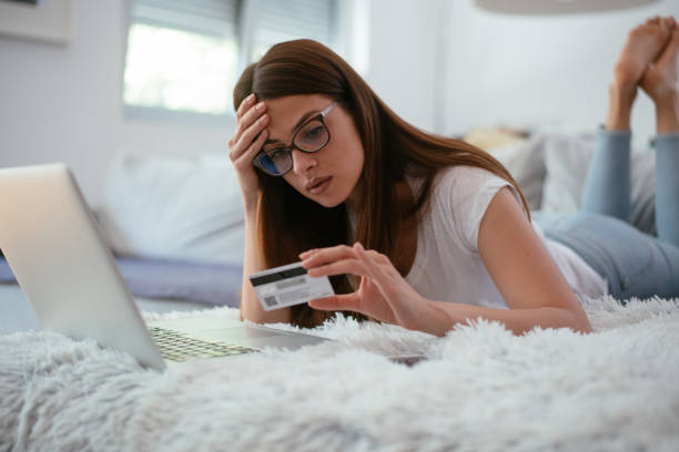 istock Worried young woman paying bills online 958940992