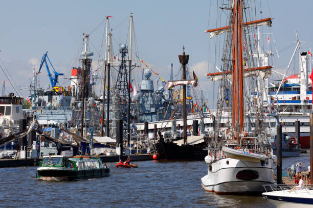 Hamburg, Germany - May 11, 2018: Hamburg harbor birthday celebration (Hafengeburtstag). One million visitors from around the world join the world’s greatest port festival each year. Variaty of masts from all kind of ships in front of the Landing Stages.
